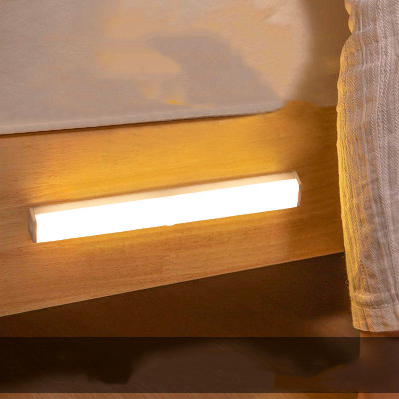 USB rechargeable LED sensor light bar mounted under a cabinet, emitting bright white light with a sleek modern design