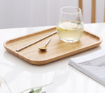 Bamboo tea and food dessert tray with handles, used for serving drinks or snacks, featuring a natural and eco-friendly design.