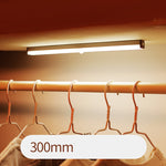 USB rechargeable LED sensor light bar mounted under a cabinet, emitting bright white light with a sleek modern design