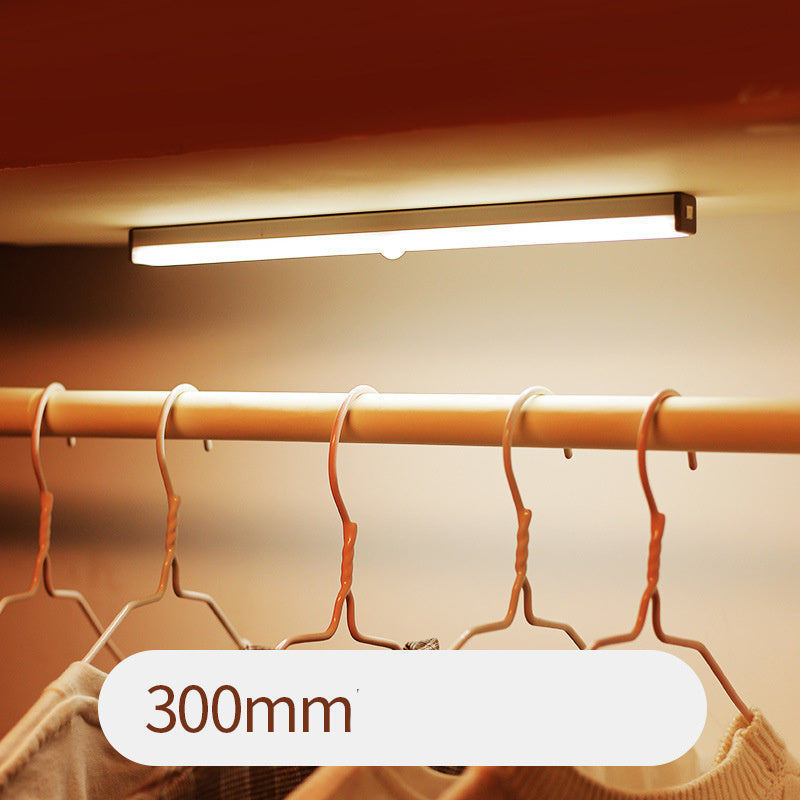 USB rechargeable LED sensor light bar mounted under a cabinet, emitting bright white light with a sleek modern design