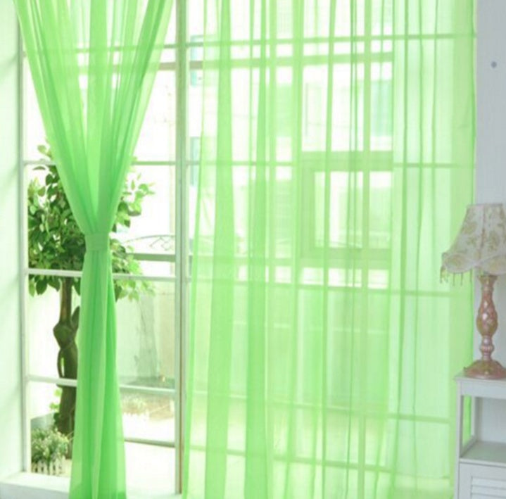 Modern tulle sheer curtains hanging in a bright living room and bedroom, allowing natural light to filter through softly