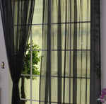 Modern tulle sheer curtains hanging in a bright living room and bedroom, allowing natural light to filter through softly