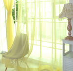 Modern tulle sheer curtains hanging in a bright living room and bedroom, allowing natural light to filter through softly