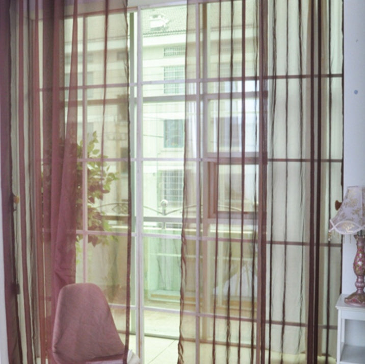 Modern tulle sheer curtains hanging in a bright living room and bedroom, allowing natural light to filter through softly