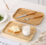 Bamboo tea and food dessert tray with handles, used for serving drinks or snacks, featuring a natural and eco-friendly design.