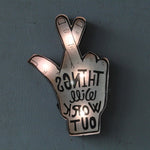 Illuminated LED neon sign featuring a hand with crossed fingers and uplifting message, great for bar or cafe ambiance lighting.