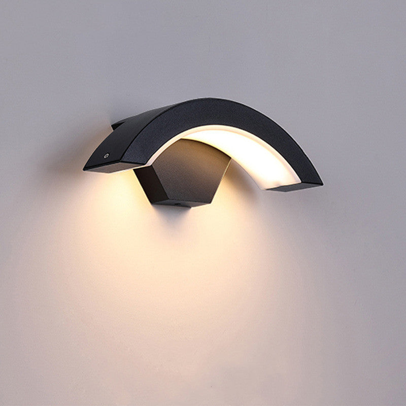 Curved Moon LED Wall Light glowing in warm white, energy-efficient and dimmable, suitable for doorways and exterior walls.