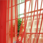 Modern tulle sheer curtains hanging in a bright living room and bedroom, allowing natural light to filter through softly