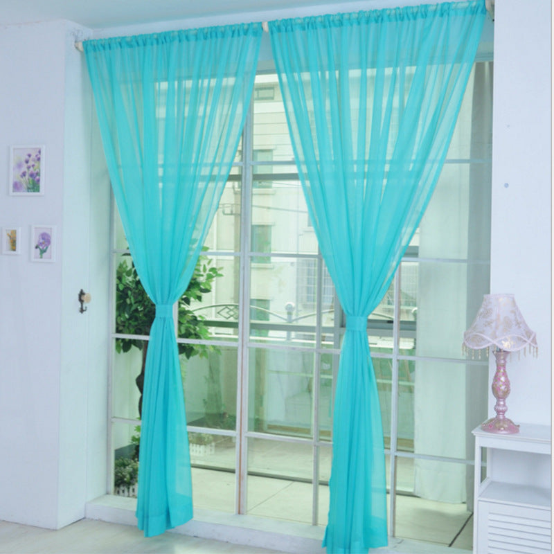 Modern tulle sheer curtains hanging in a bright living room and bedroom, allowing natural light to filter through softly