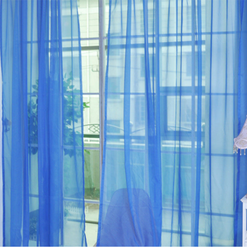 Modern tulle sheer curtains hanging in a bright living room and bedroom, allowing natural light to filter through softly