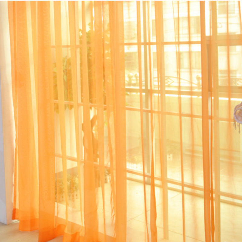 Modern tulle sheer curtains hanging in a bright living room and bedroom, allowing natural light to filter through softly