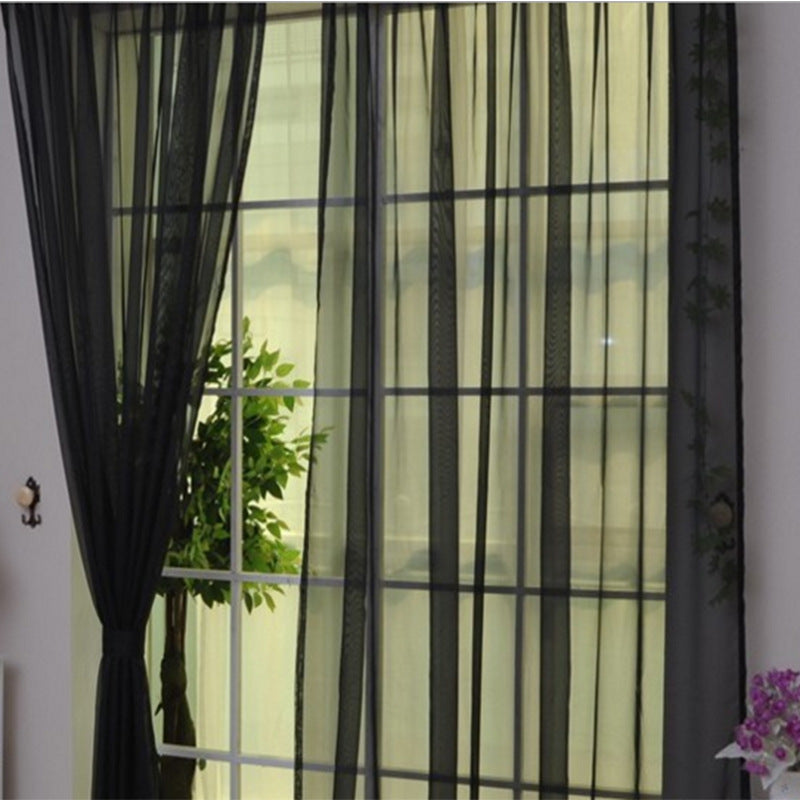 Modern tulle sheer curtains hanging in a bright living room and bedroom, allowing natural light to filter through softly