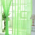 Modern tulle sheer curtains hanging in a bright living room and bedroom, allowing natural light to filter through softly