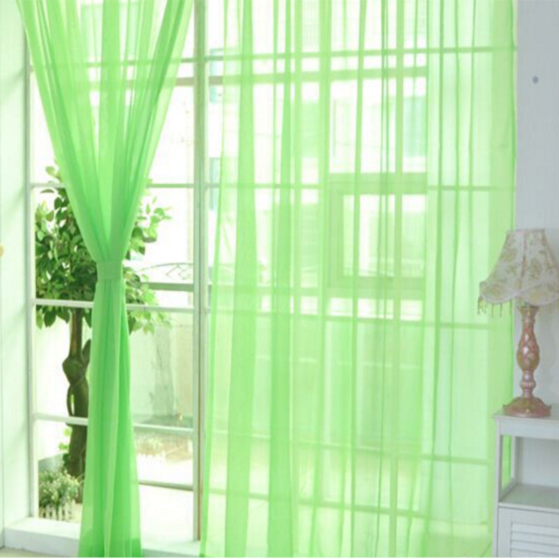 Modern tulle sheer curtains hanging in a bright living room and bedroom, allowing natural light to filter through softly