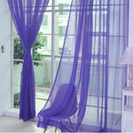 Modern tulle sheer curtains hanging in a bright living room and bedroom, allowing natural light to filter through softly