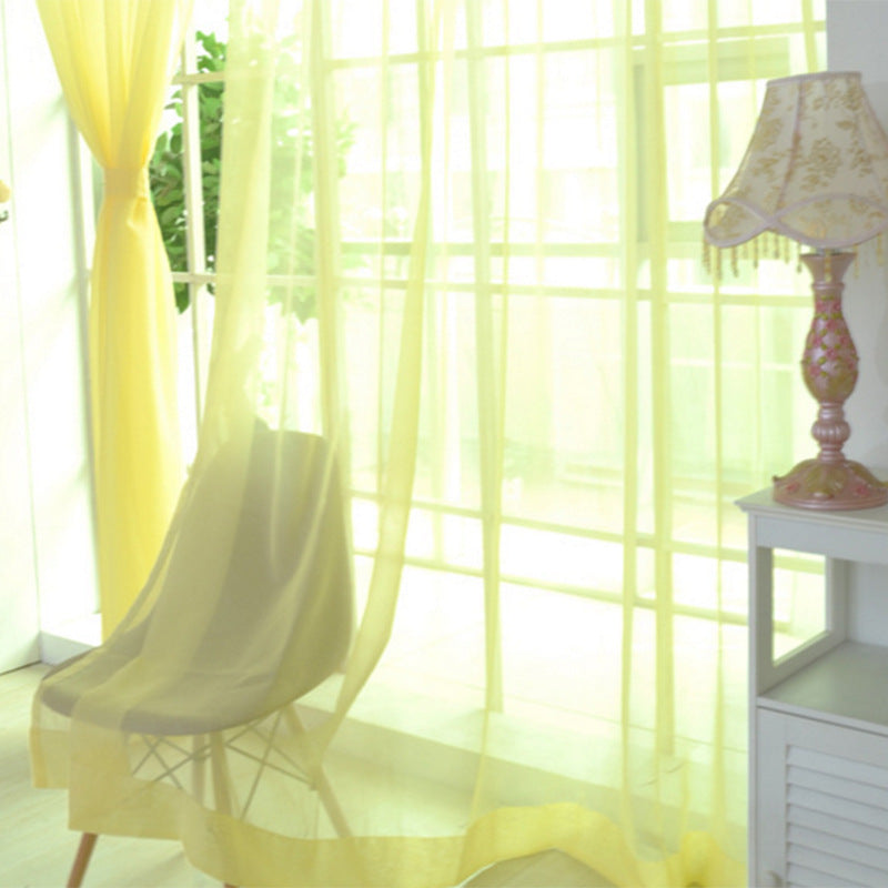Modern tulle sheer curtains hanging in a bright living room and bedroom, allowing natural light to filter through softly