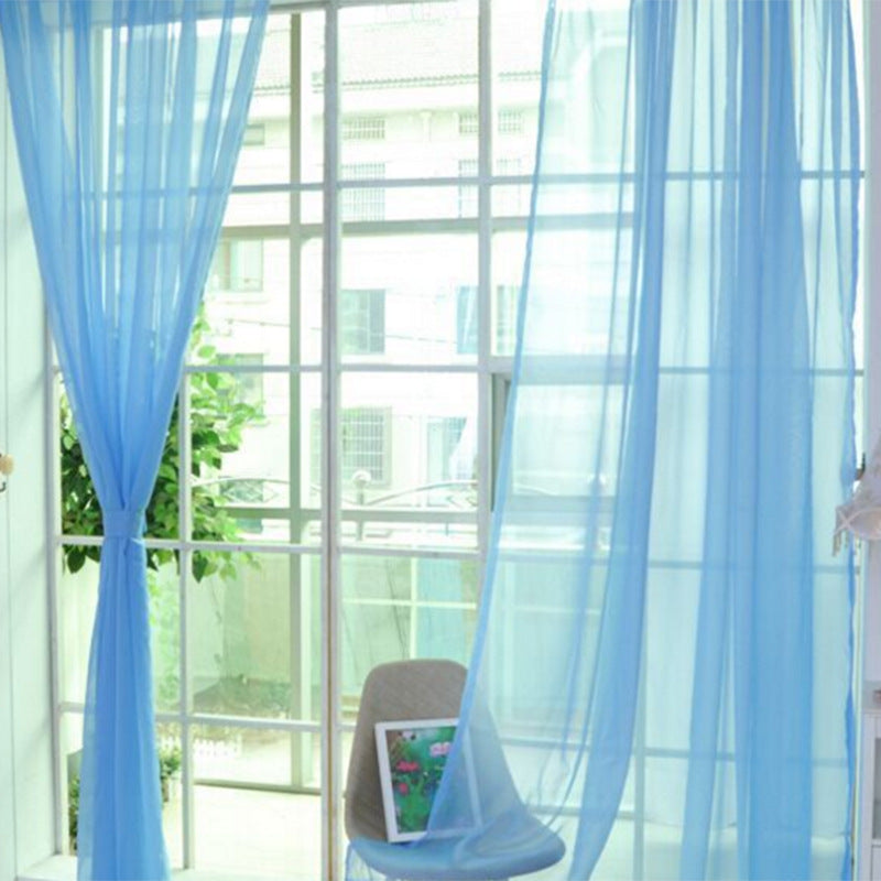 Modern tulle sheer curtains hanging in a bright living room and bedroom, allowing natural light to filter through softly