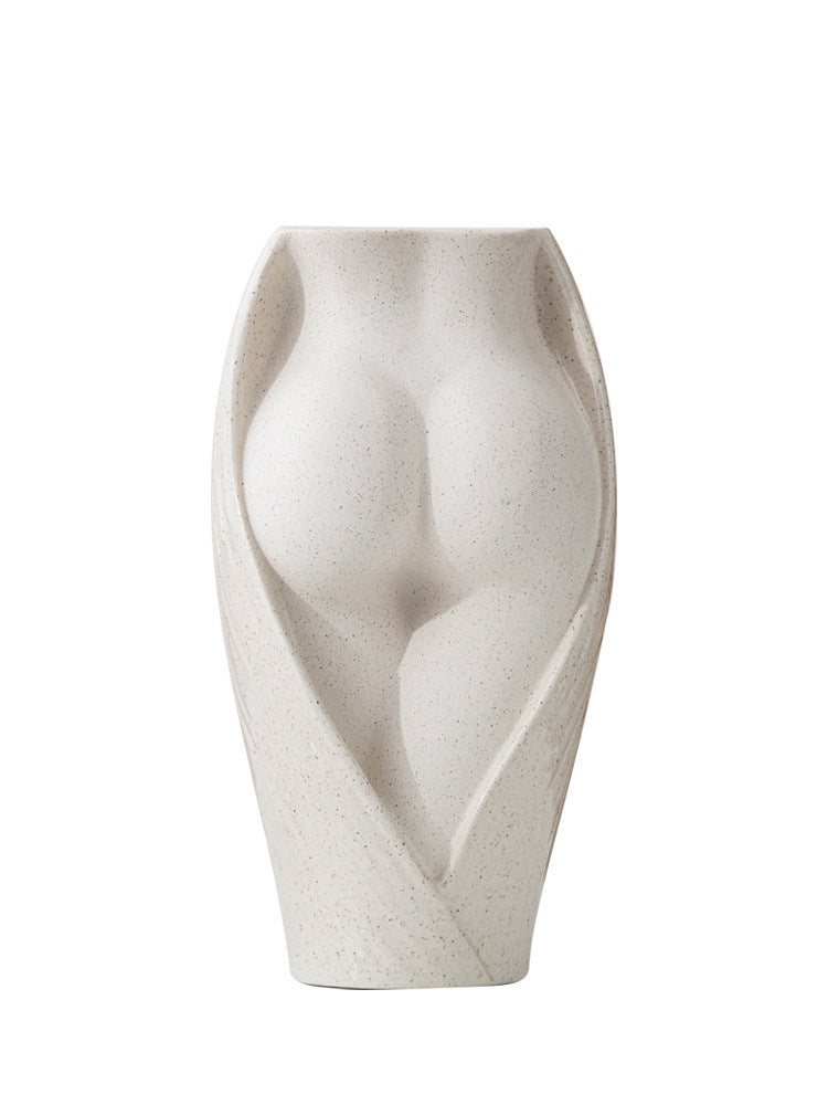 Modern ceramic vase featuring a sculpted female torso design in matte beige, perfect for artistic floral arrangements or standalone decor.