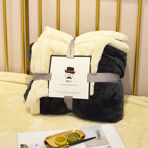 Soft flannel fleece blanket draped over a sofa and bed, providing warmth and cozy comfort for home use