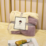 Soft flannel fleece blanket draped over a sofa and bed, providing warmth and cozy comfort for home use
