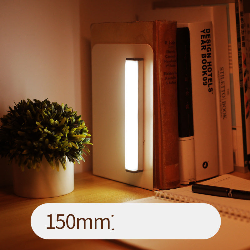USB rechargeable LED sensor light bar mounted under a cabinet, emitting bright white light with a sleek modern design