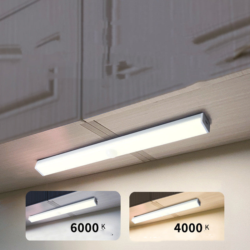 USB rechargeable LED sensor light bar mounted under a cabinet, emitting bright white light with a sleek modern design