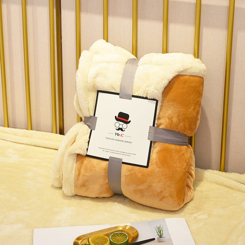 Soft flannel fleece blanket draped over a sofa and bed, providing warmth and cozy comfort for home use