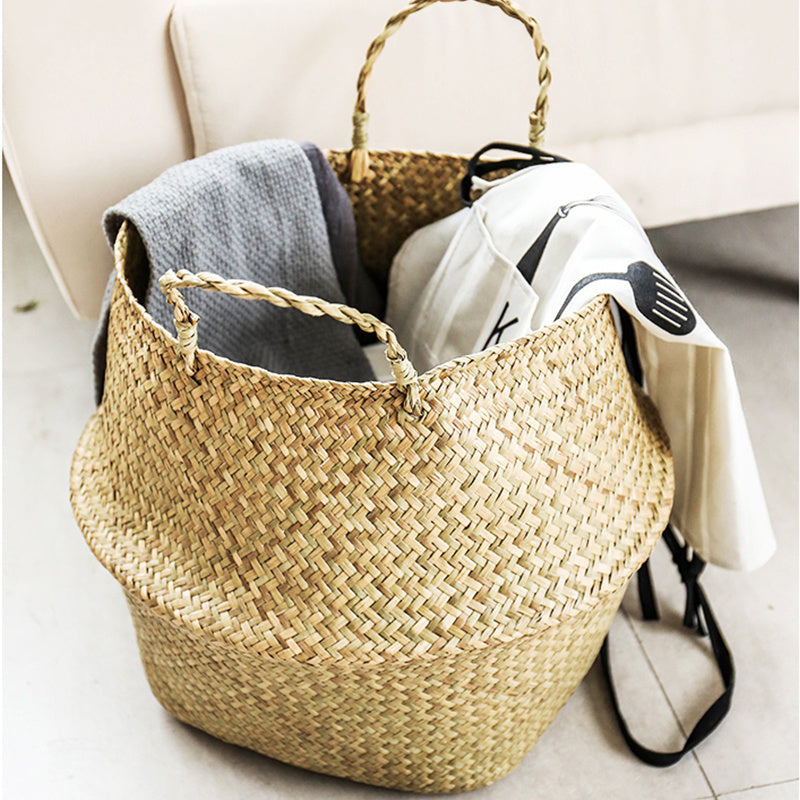 Portable seagrass woven flower storage basket with handles, used for organizing items or displaying plants in natural home decor style