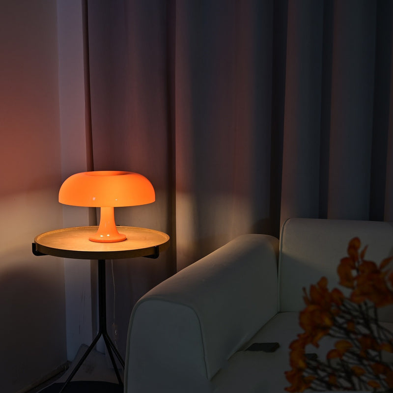 Orange Decorative Mushroom Lamp on a side table beside a sofa, creating cozy lighting for bedroom or living room interiors.