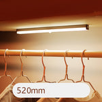 USB rechargeable LED sensor light bar mounted under a cabinet, emitting bright white light with a sleek modern design
