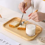 Bamboo tea and food dessert tray with handles, used for serving drinks or snacks, featuring a natural and eco-friendly design.