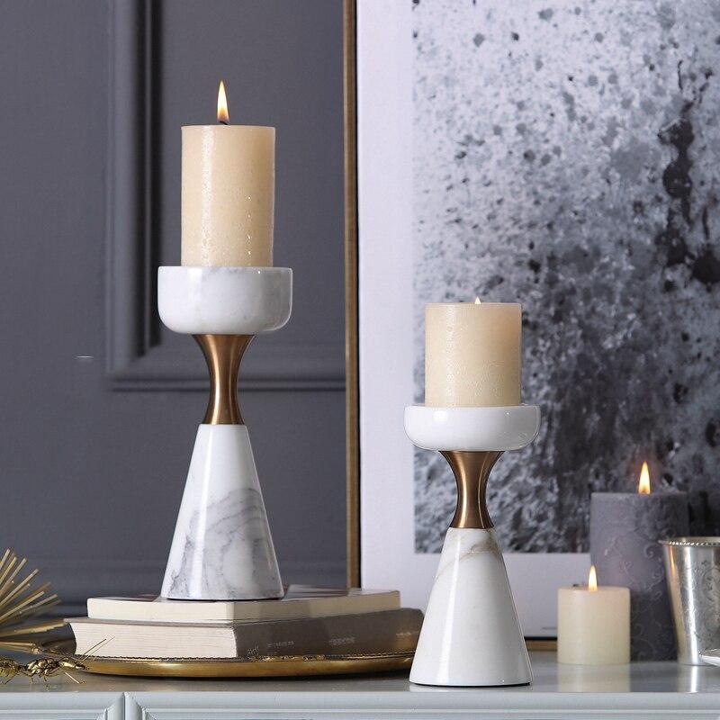 Set of Elegant Marble Candle Holders with lit candles on a console table, showcasing timeless design for sophisticated interiors.
