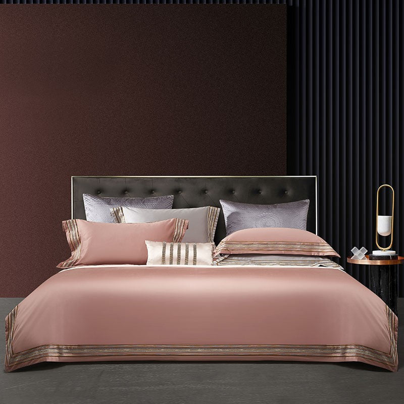Elegant 4-piece embroidered bedding set with 140 thread count, displayed on a neatly made bed for a luxurious bedroom look