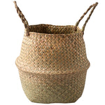 Portable seagrass woven flower storage basket with handles, used for organizing items or displaying plants in natural home decor style