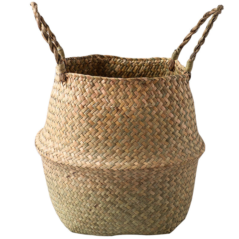 Portable seagrass woven flower storage basket with handles, used for organizing items or displaying plants in natural home decor style