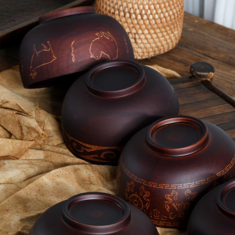 Ethnic wooden bowl with intricate carved patterns, showcasing traditional craftsmanship and rustic decorative style