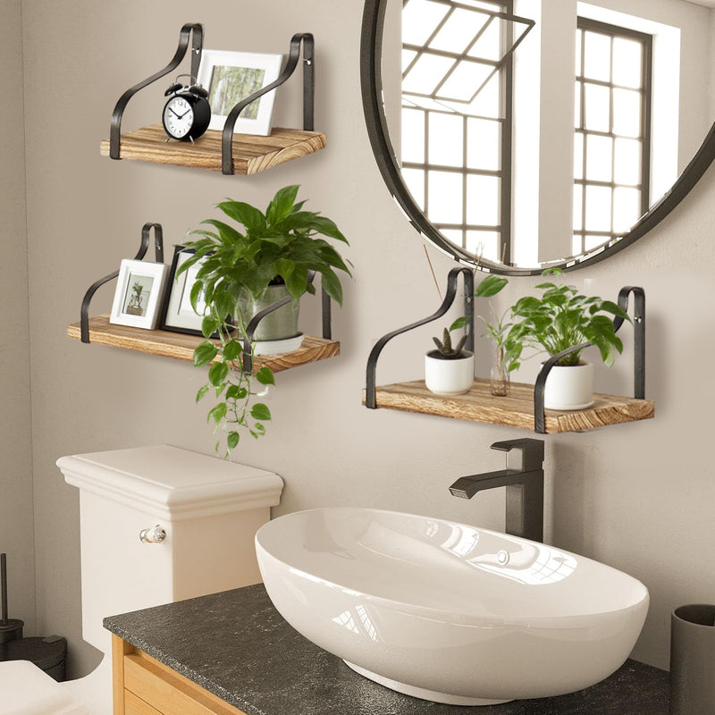 Wood Floating Shelves - Set of 3 mounted in a bathroom, decorated with plants and framed photos, ideal for stylish and functional wall storage.