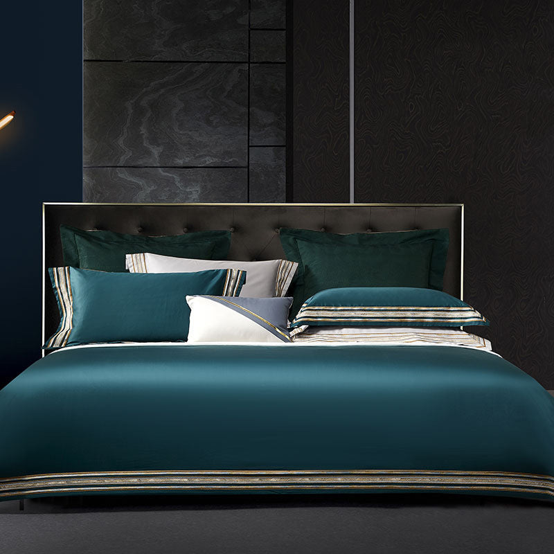 Elegant 4-piece embroidered bedding set with 140 thread count, displayed on a neatly made bed for a luxurious bedroom look