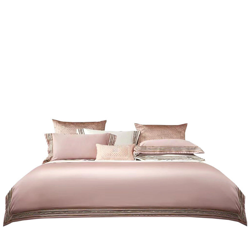 Elegant 4-piece embroidered bedding set with 140 thread count, displayed on a neatly made bed for a luxurious bedroom look