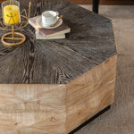 Angled view of Retro Octagon Coffee Table with decorative items on top, highlighting the contrast between dark top and light wood base.