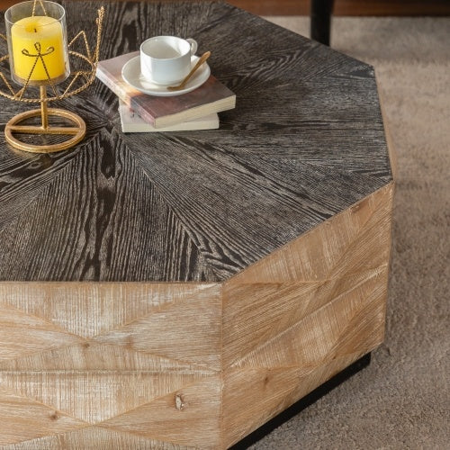 Angled view of Retro Octagon Coffee Table with decorative items on top, highlighting the contrast between dark top and light wood base.
