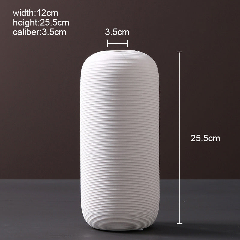 Scandinavian ceramic vase with a minimalist design, perfect for modern home decor and displaying fresh or dried flowers.