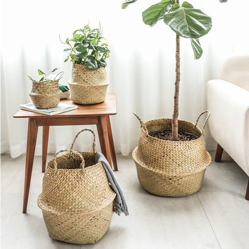 Portable seagrass woven flower storage basket with handles, used for organizing items or displaying plants in natural home decor style