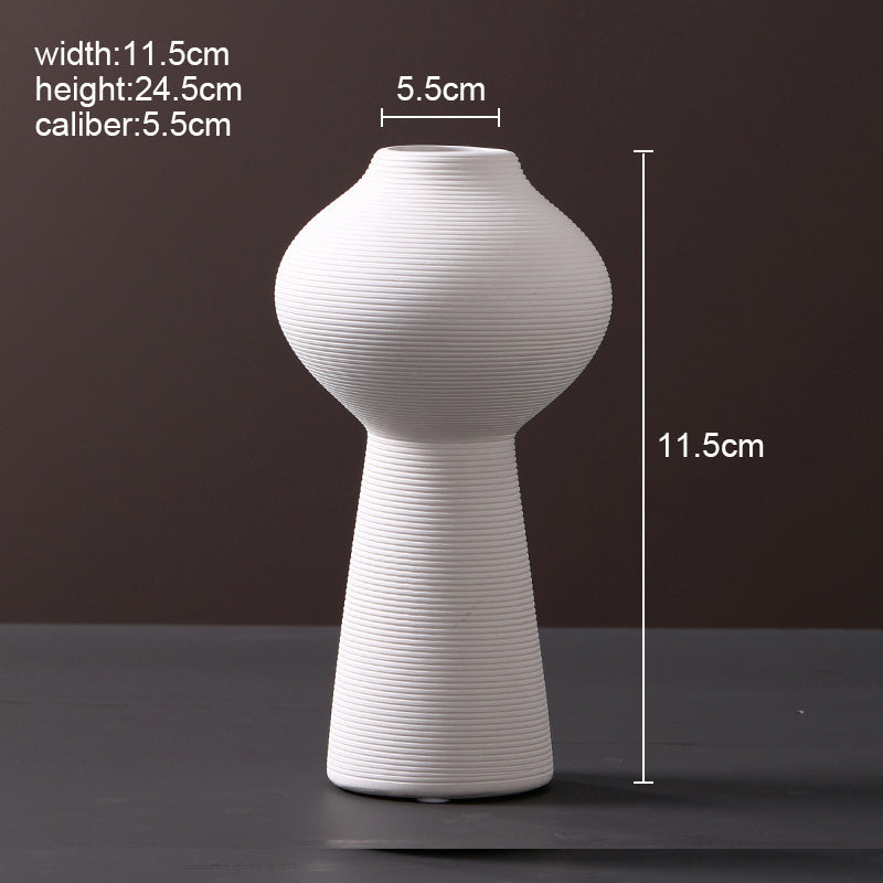 Scandinavian ceramic vase with a minimalist design, perfect for modern home decor and displaying fresh or dried flowers.