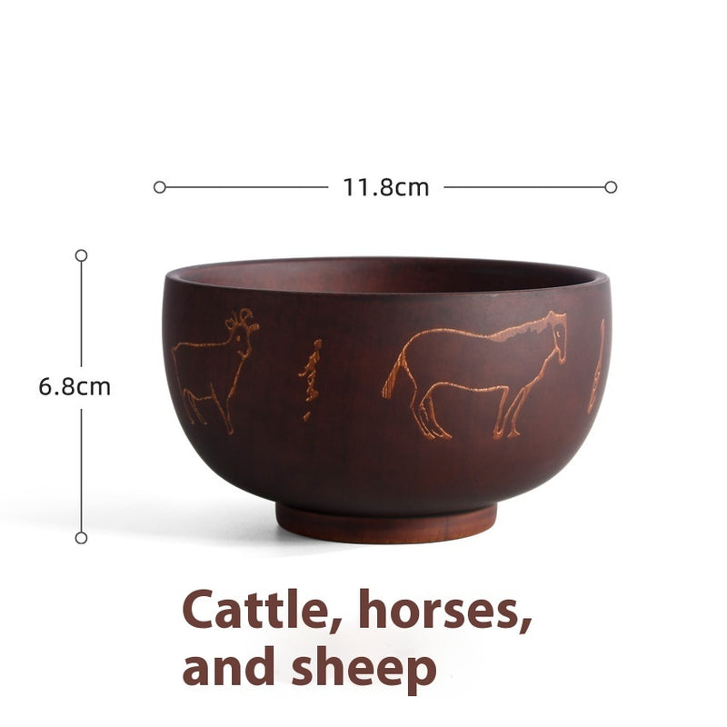 Ethnic wooden bowl with intricate carved patterns, showcasing traditional craftsmanship and rustic decorative style