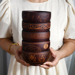 Ethnic wooden bowl with intricate carved patterns, showcasing traditional craftsmanship and rustic decorative style