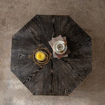 Top view of Retro Octagon Coffee Table showing dark wood grain surface with decorative items, highlighting its compact and stylish design.