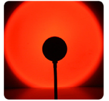 Red glow from Sunset Projection Lamp - Adjustable Decor, casting a bold circular light for dramatic night lighting ambiance.