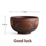 Ethnic wooden bowl with intricate carved patterns, showcasing traditional craftsmanship and rustic decorative style