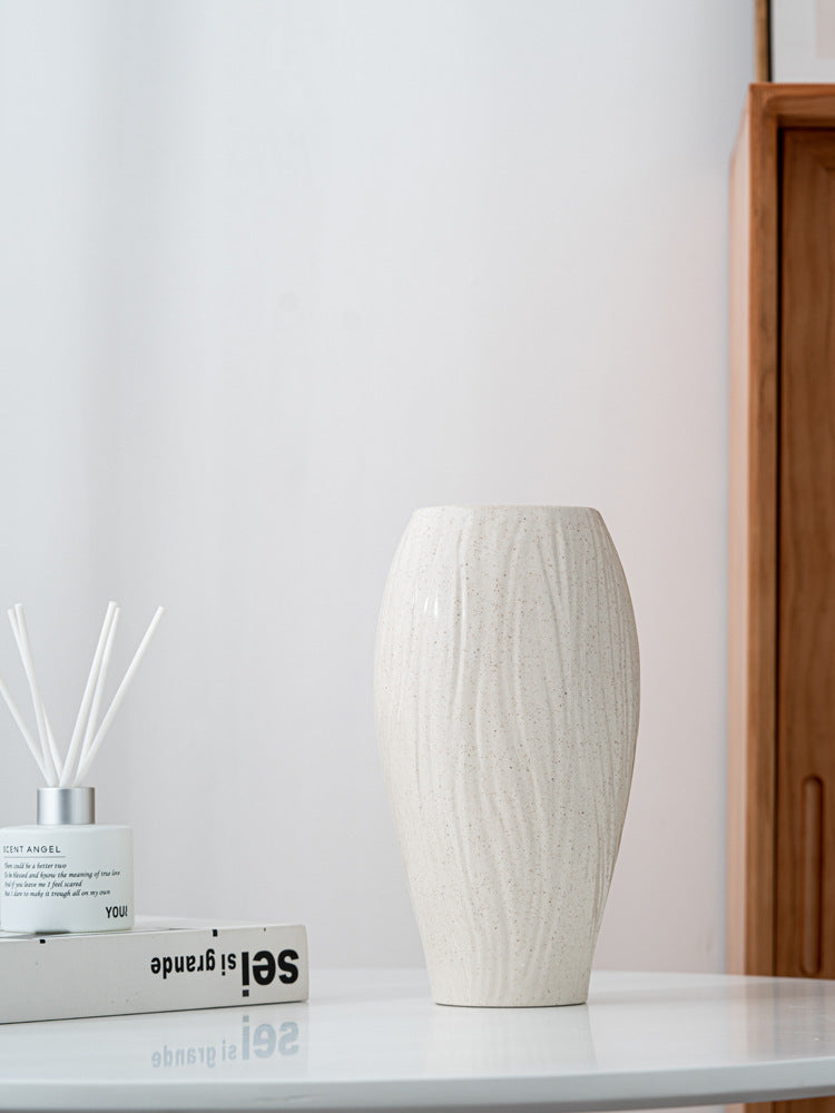 Back view of simple modern ceramic vase with textured finish, showcasing its smooth curves and neutral tone for versatile home styling.